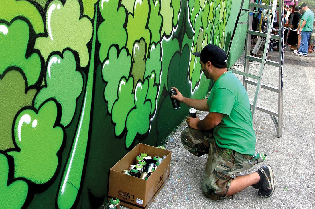 Tampa-based artist Stephen Palladino painted a 40-foot clover mural for Shamrock's St. PatrickÃ¢â‚¬â„¢s Day party. Photo by Nick Friedman.