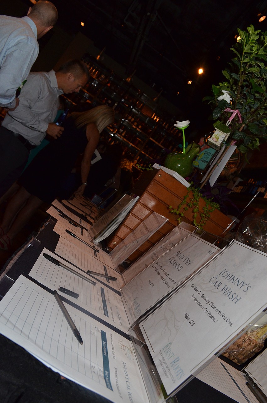 Parents bid on donated silent auction items to raise money for the preschool.