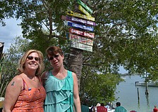 Cathy Minter and Wendy Holmberg enjoy the afternoon at Casey Key Fish House. Minter has a blue ribbon temporary tattoo to show her support during National Child Abuse Prevention month.