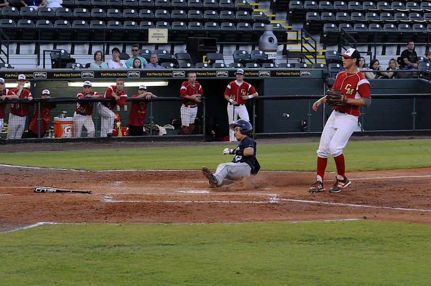ODA freshman Parke Phillips slides into home plate in the top of the third inning.
