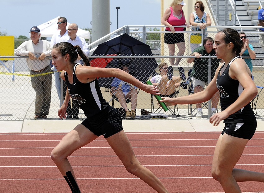 Lakewood Ranch senior Olivia Ortiz receives the handoff from her younger sister Julia during the 4x800 relay.