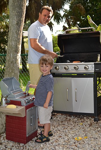 Tom Cail and his son, Jaxon, man their grills. Courtesy photo.
