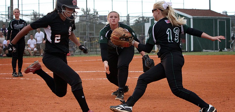 Strawberry Crestâ€™s Sarah Rowley, No. 2, touches first base after Lakewood Ranchâ€™s Katie Hopkins, No. 20, throws the ball to Lakewood Ranchâ€™s Jenn Trotter, No. 13, but before Trotter could touch the base. Rowley was safe.