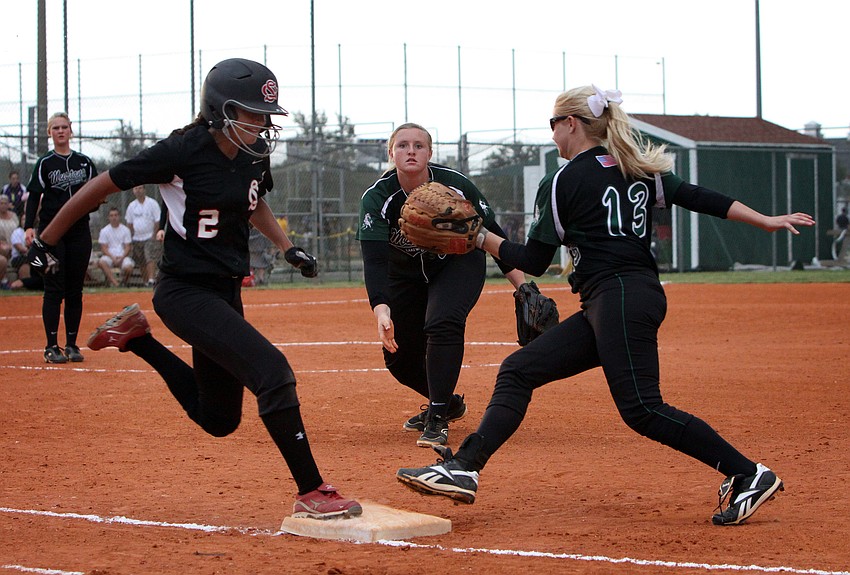 Strawberry Crestâ€™s Sarah Rowley, No. 2, touches first base after Lakewood Ranchâ€™s Katie Hopkins, No. 20, throws the ball to Lakewood Ranchâ€™s Jenn Trotter, No. 13, but before Trotter could touch the base. Rowley was safe.