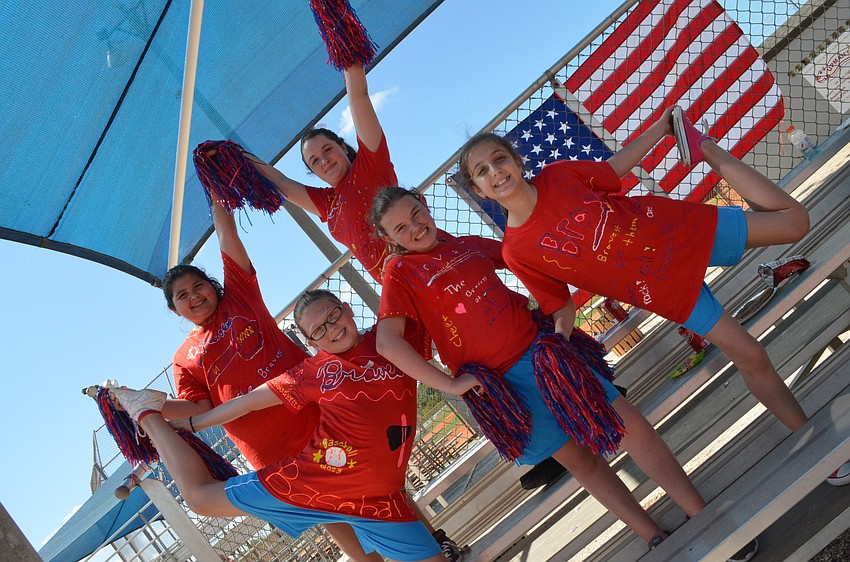 Cheerleaders (bottom) Emily McCalla, Brianna Raphael, Pamela Xhoxhi (top) Alexandra Garcia and Ashley Sanders enliven the crowd with their chants.