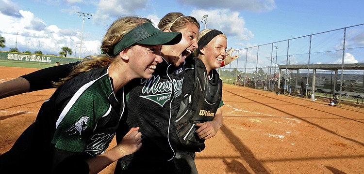 Sierra Schappacher, Jackie Schoff and Talli Sharp celebrate following Lakewood Ranchâ€™s 8-3 victory over River Ridge in the Class 6A-Region 3 finals May 3.