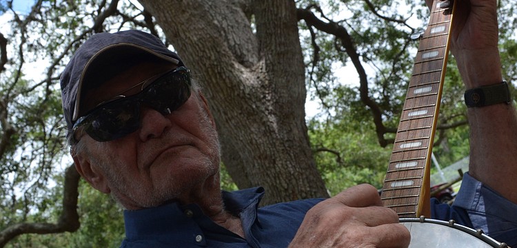 Bernie Gerstein plays the banjo at the Arlington Park Neighborhood Association Picnic. Gerstein is a snowbird that lives between Sarasota and Iowa.