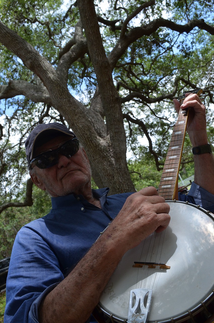 Bernie Gerstein plays the banjo at the Arlington Park Neighborhood Association Picnic. Gerstein is a snowbird that lives between Sarasota and Iowa.