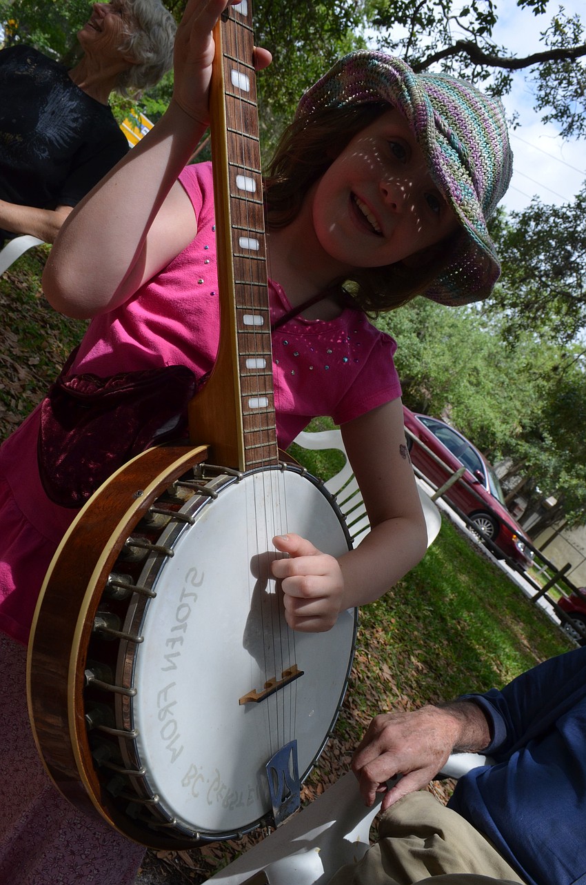 Ophelia Gould, 6, sings Sunny Side Today and strums the banjo.