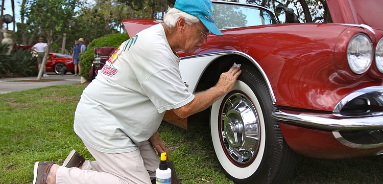 Joe Hansen shines up the wheels of his 1961 Corvette.