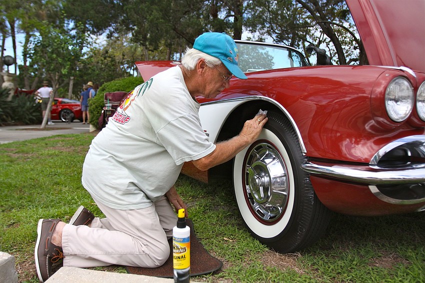 Joe Hansen shines up the wheels of his 1961 Corvette.