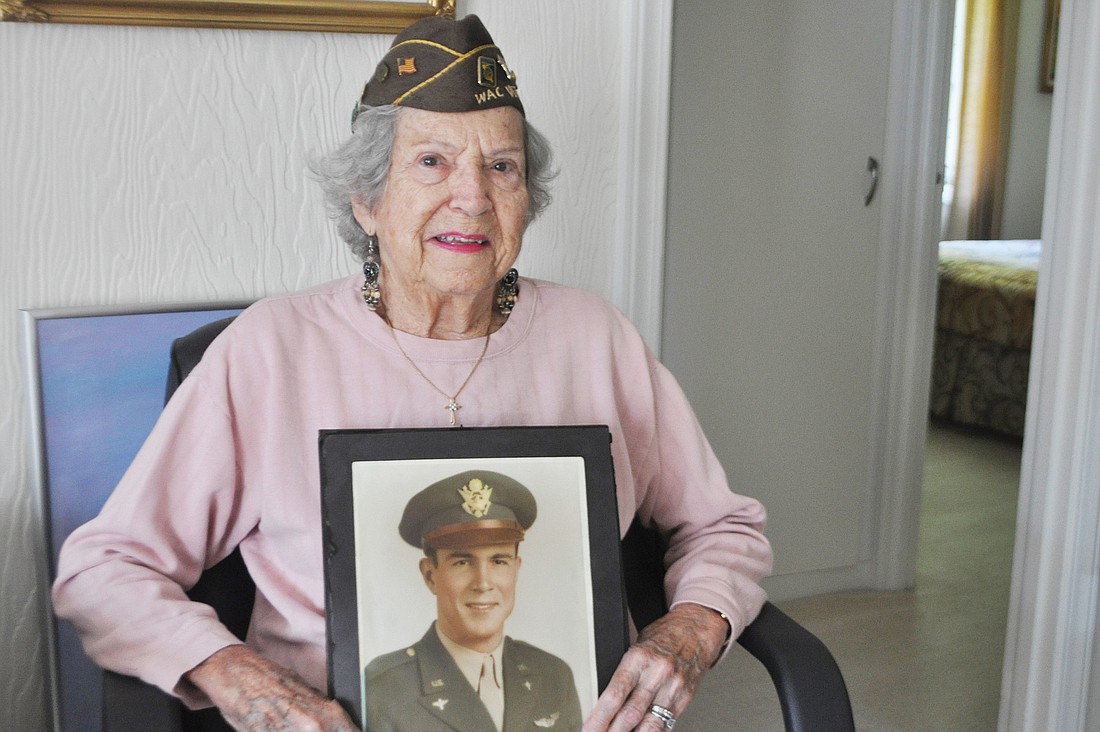 Shirley Beachum holds a portrait of her late husband, pilot Grady Hunt, who was killed in action in 1943. Photo by Robin Hartill.