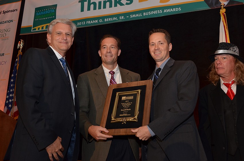 Publisher of the Herald Tribune Media Group Patrick Dorsey presents Paul Hoffman and Nathan Bailey of SouthTech with Small Business of the Year award.
