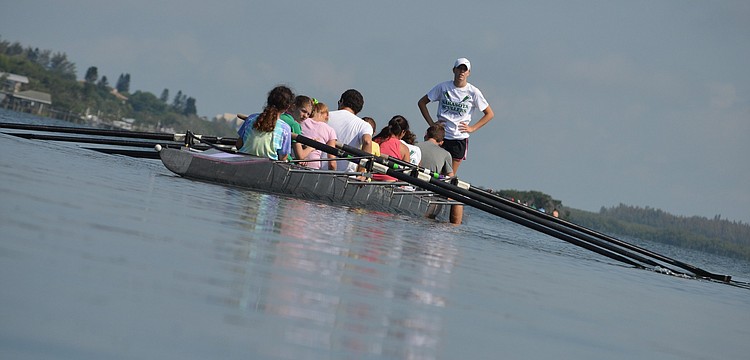 Captain Payton Harris supervises parents as they row out.