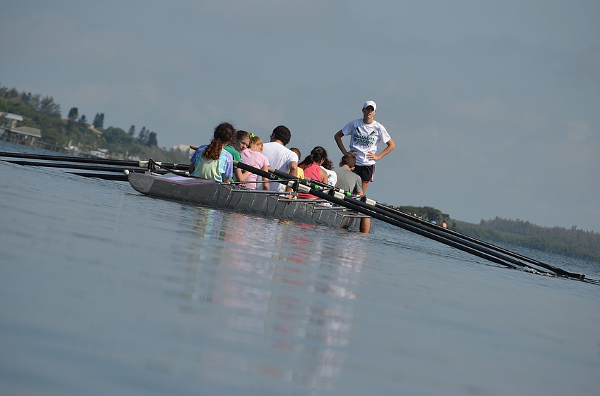Captain Payton Harris supervises parents as they row out.