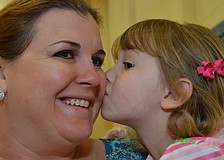 Olivia Daige gives her mom Stephanie a kiss on the cheek.