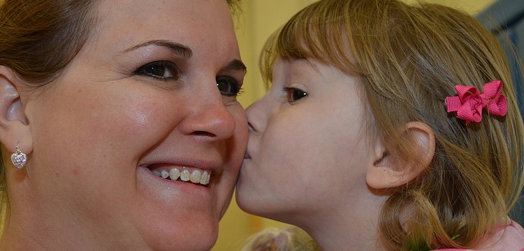 Olivia Daige gives her mom Stephanie a kiss on the cheek.