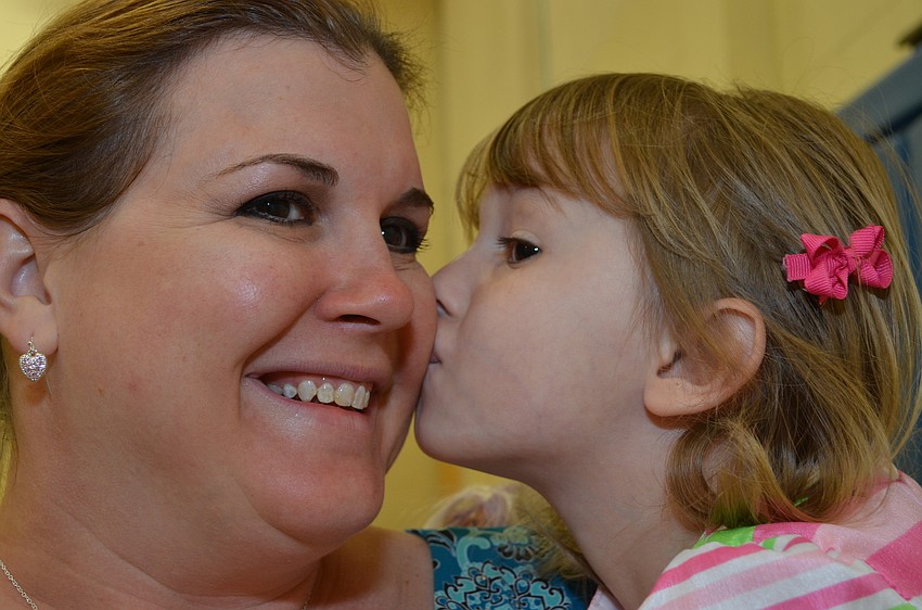 Olivia Daige gives her mom Stephanie a kiss on the cheek.