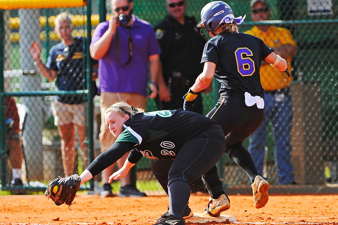 Lakewood Ranch senior Katie Hopkins secures a throw back to first base for an out. Photo by Brian Blanco.