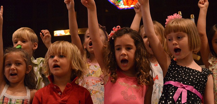 Avery Johanning, Tucker Gravly, Grace Hollingsworth and Noelle Tenaglia sing the Kindergarten Song for parents in the sanctuary.