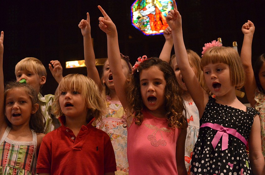 Avery Johanning, Tucker Gravly, Grace Hollingsworth and Noelle Tenaglia sing the Kindergarten Song for parents in the sanctuary.