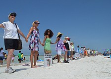 Supporters of a cleaner environment join hands.