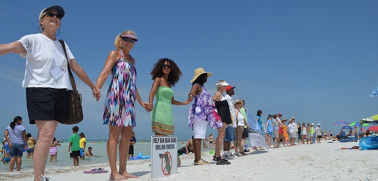 Supporters of a cleaner environment join hands.
