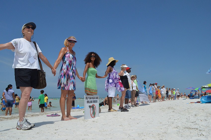 Supporters of a cleaner environment join hands.