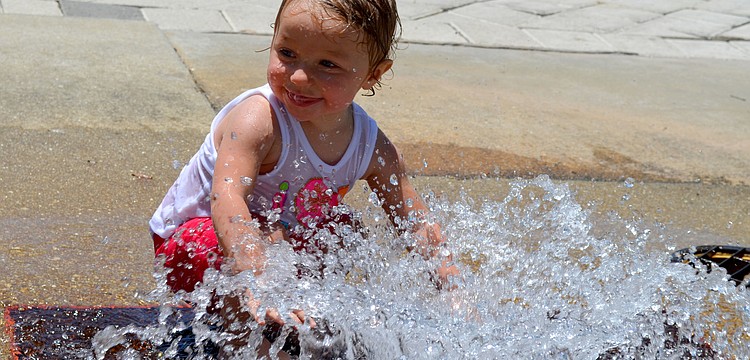 Juliana plays in the water fountain.