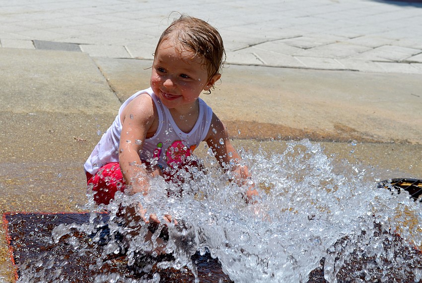 Juliana plays in the water fountain.