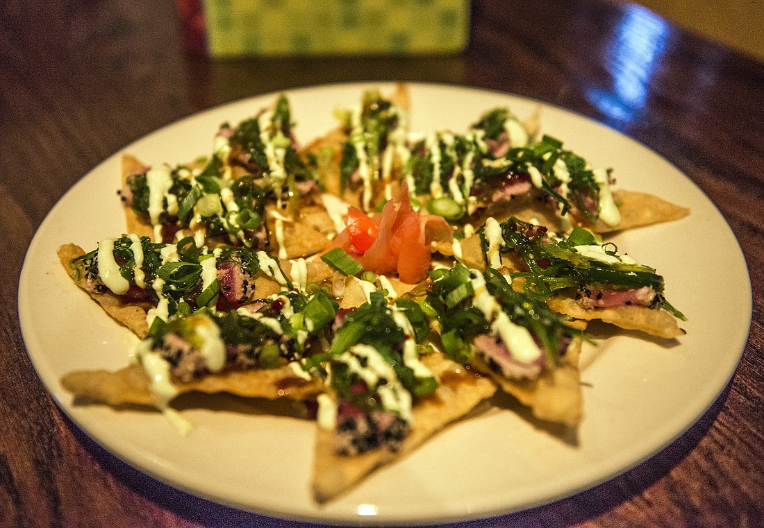 Nouveau nachos: seared, sesame-crusted yellowfin tuna and seaweed salad on a crispy wonton wrapper at Gecko's. Cliff Roles.