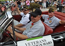 VFW Post 12055 member and veteran George Johnston drives fellow veterans in the parade.