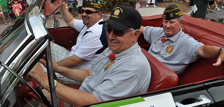 VFW Post 12055 member and veteran George Johnston drives fellow veterans in the parade.