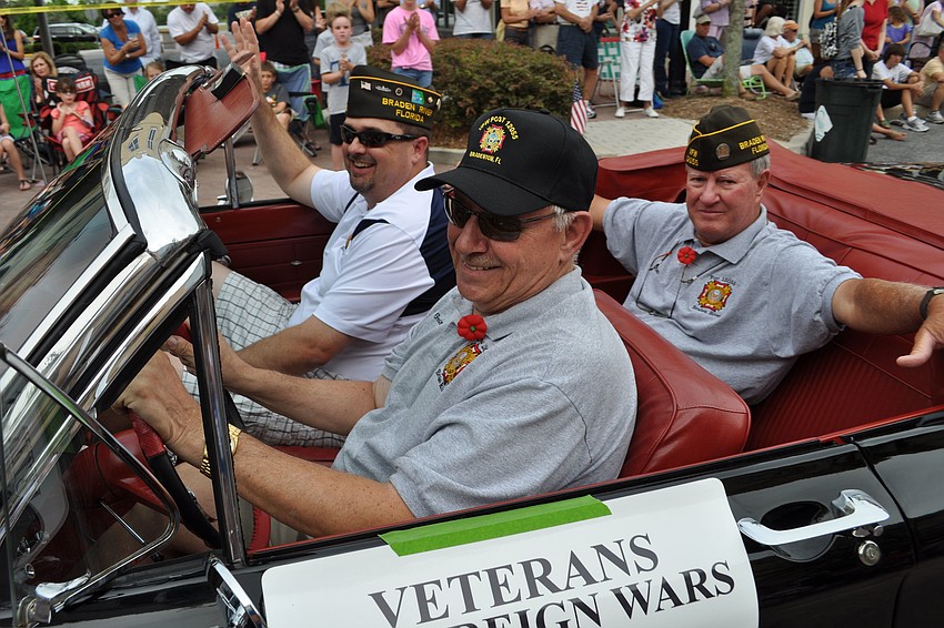 VFW Post 12055 member and veteran George Johnston drives fellow veterans in the parade.