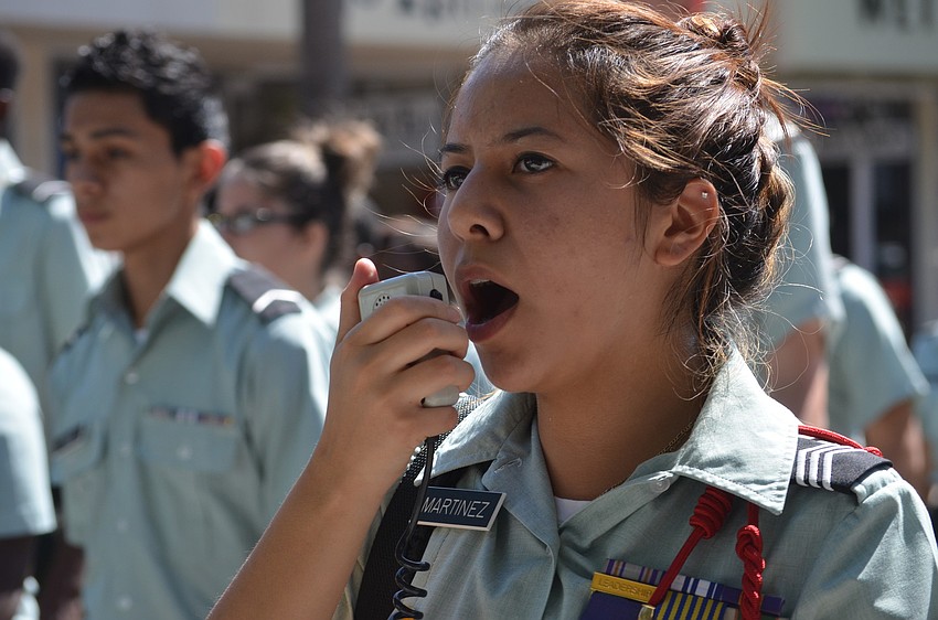 Booker High School JROTC cadet projects orders over the speaker.