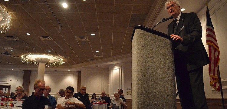 President of the Sarasota County Veterans Commission Andy Hooker calls veteran Rick Rogala up to accept his award for service.