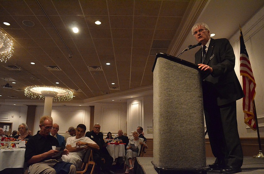 President of the Sarasota County Veterans Commission Andy Hooker calls veteran Rick Rogala up to accept his award for service.