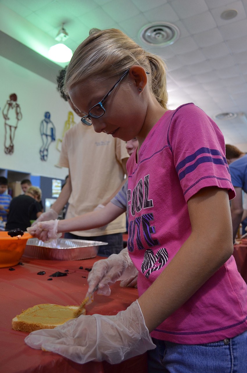 Fourth grader Samantha Sineath spread soy butter on white bread.