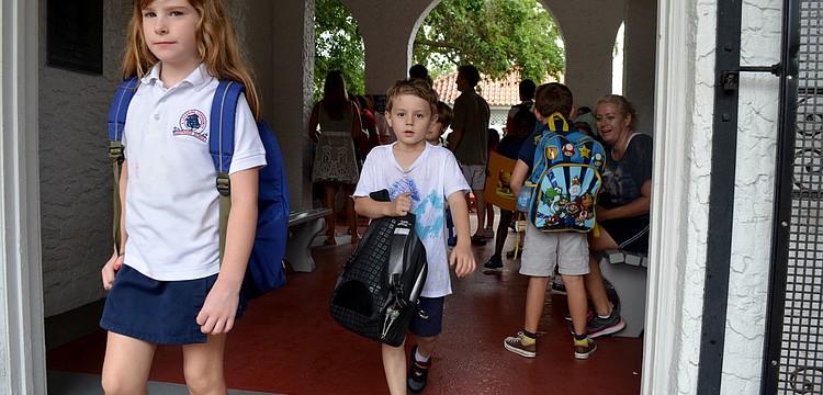 Children leave Southside Elementary for the bus stop on the last day of school.