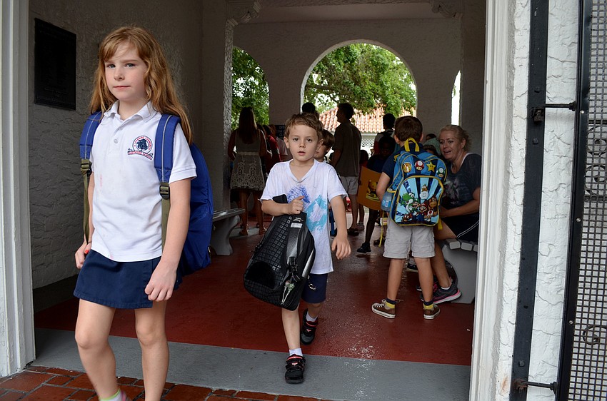 Children leave Southside Elementary for the bus stop on the last day of school.