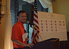 YPG Chairman Sam Davidson reminds golfers to bid on silent auction items before it closes.