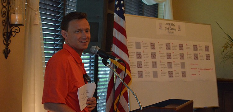 YPG Chairman Sam Davidson reminds golfers to bid on silent auction items before it closes.