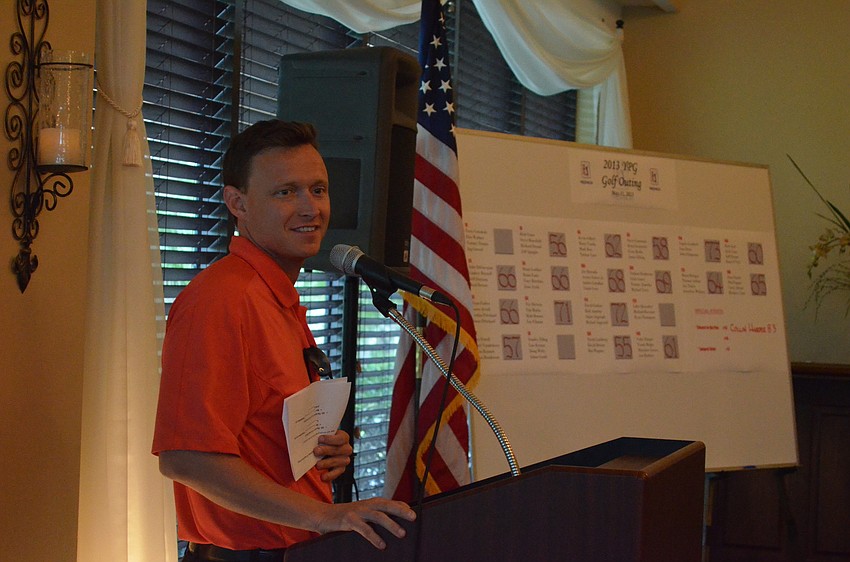 YPG Chairman Sam Davidson reminds golfers to bid on silent auction items before it closes.