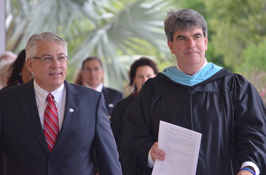 Chairman of the Board of Trustees Michael vonWaldner and Head of School David Mahler walk to the ceremony from the Arts Center.