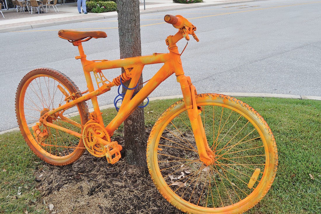 This bike is one of 13 spray-painted bikes locked up at shopping centers along University Parkway.