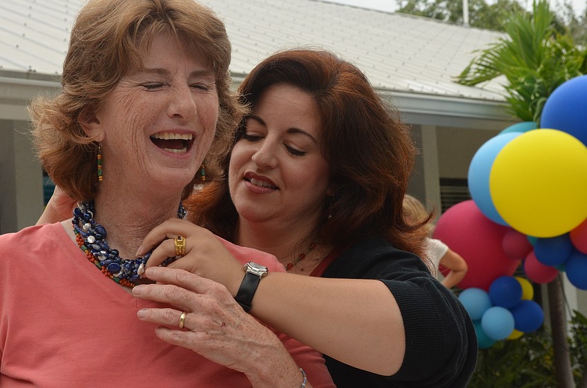 Alyssa Mandel puts a torsade necklace she made for Glnedy Huene around her neck. â€œI will think of you as I wear the ODA blue,â€ Glendy Huene said.