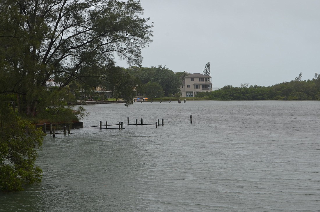 A dock in the Longboat Pass lagoon is overtaken by water after high tide Thursday.