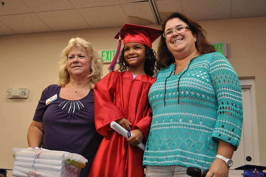 Dereon Lovette center, posed for a picture with her Kiddie Academy teachers, Debbie Frazzoni, left, and Karen Kieran, right, after receiving her diploma.