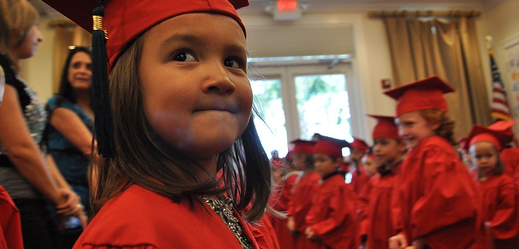 Elia Shen, of Primrose, looks for her parents as she marches into the room.