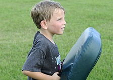 Six-year-old Kayden Carroll enjoyed smashing into people during the offensive line drills.